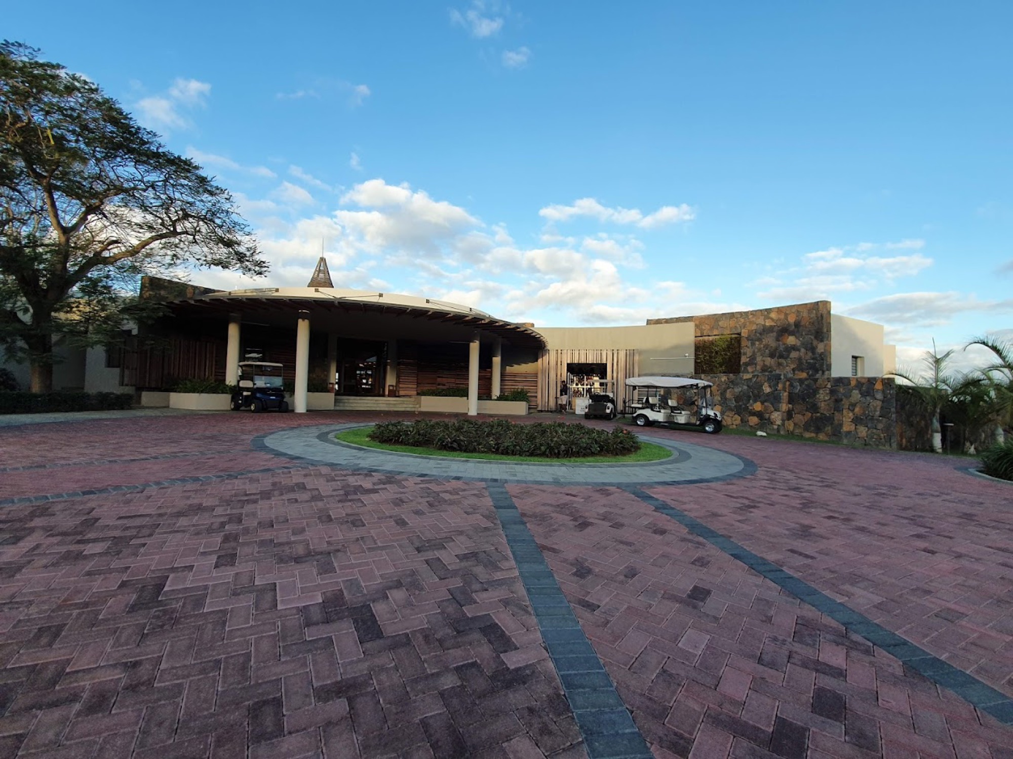 Clubhouse and pool deck with loungers and palms
