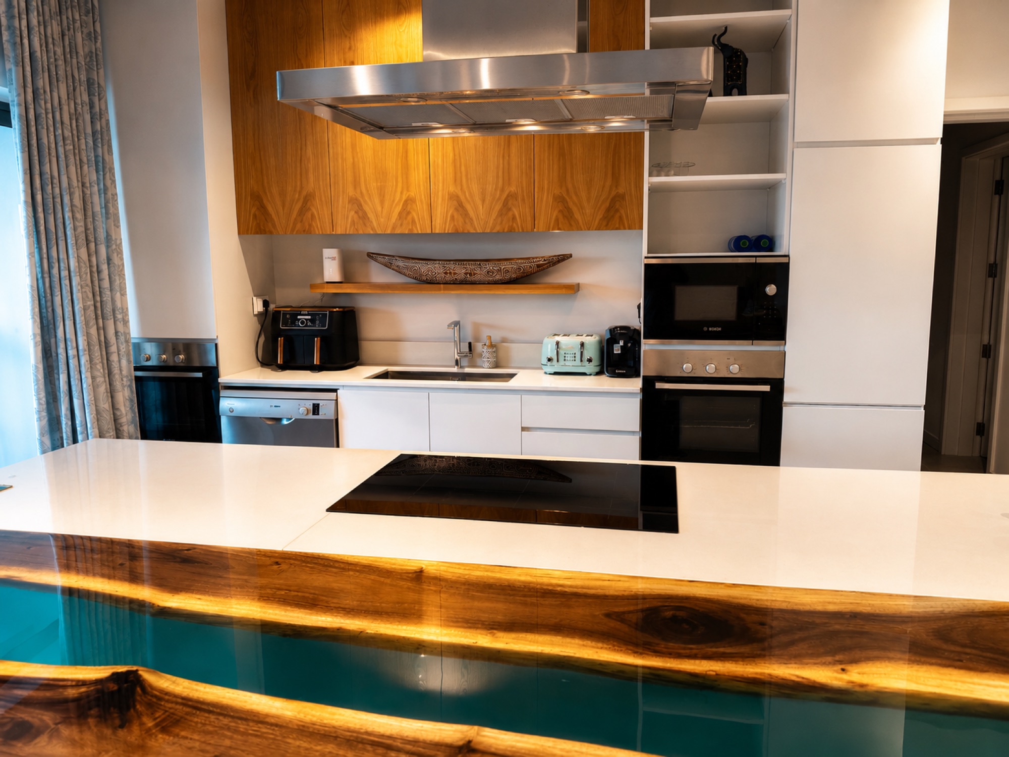 Designer kitchen detail with ceramic hob and ovens